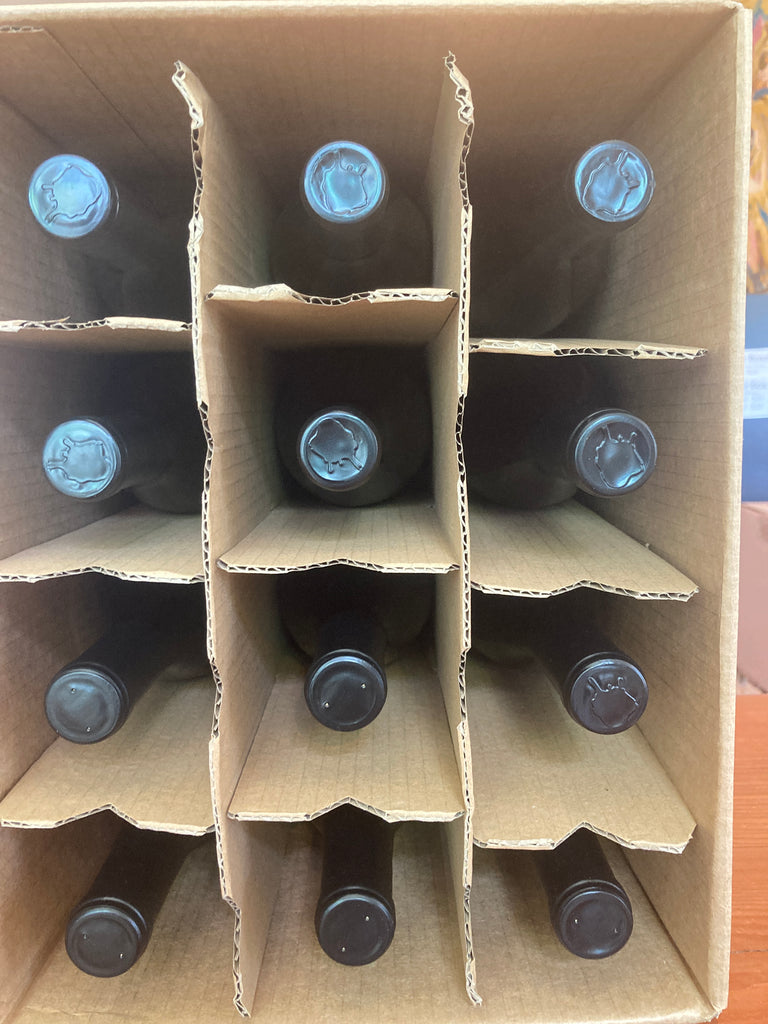 Cardboard box with cutouts for bottles, filled with dark bottles.